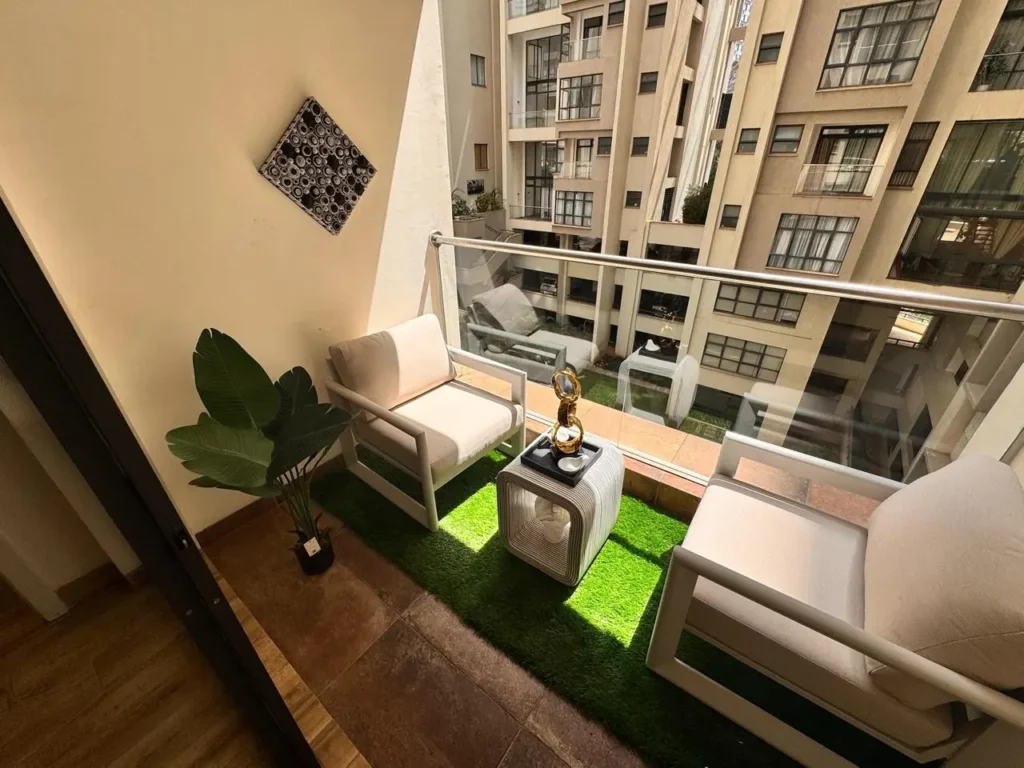 1. Cozy balcony outdoor lounge with turf finish overlooking the inner courtyard at Rumaisa Residency, Nairobi.