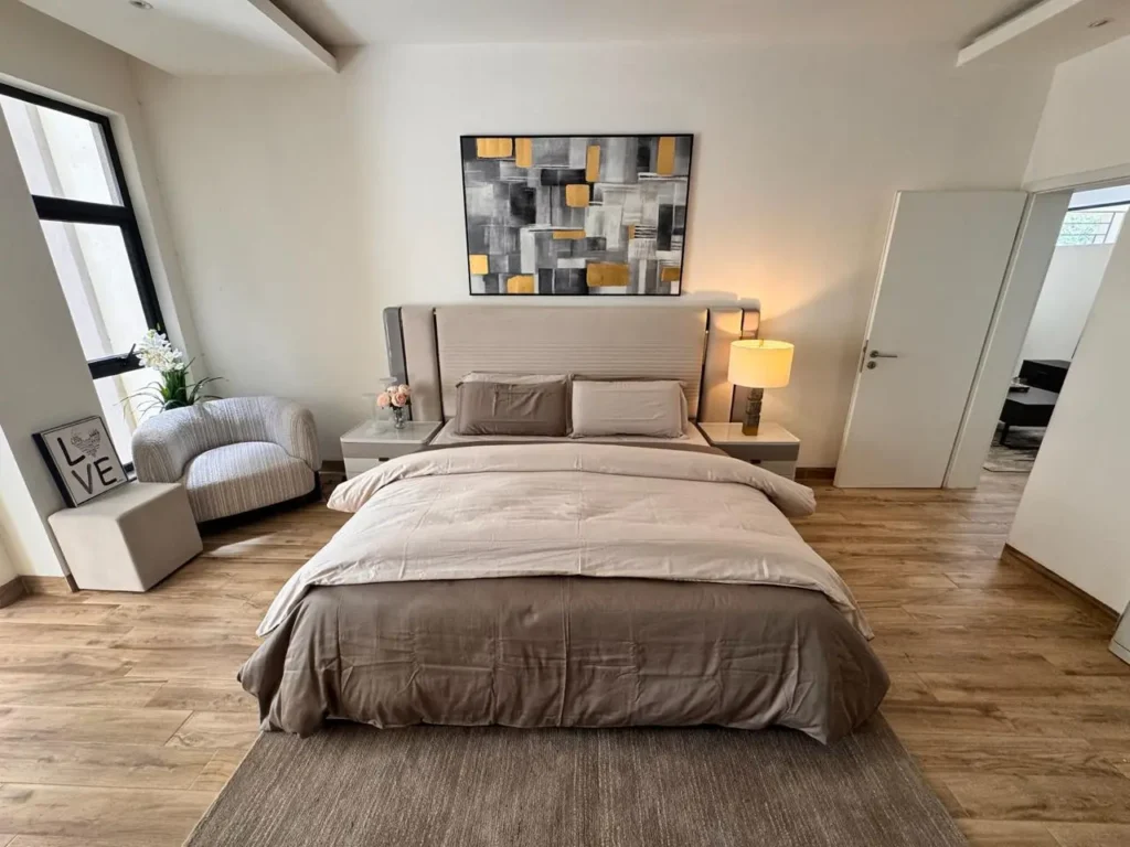 Bright bedroom with modern grey-toned styling and premium flooring at Rumaisa Residency, Riverside Drive Nairobi.