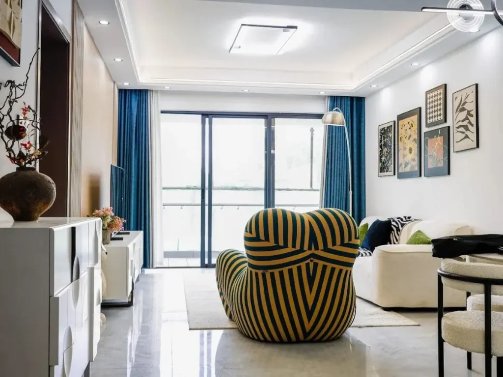 Spacious apartment living room at Capital Heights with stylish furniture and balcony access.