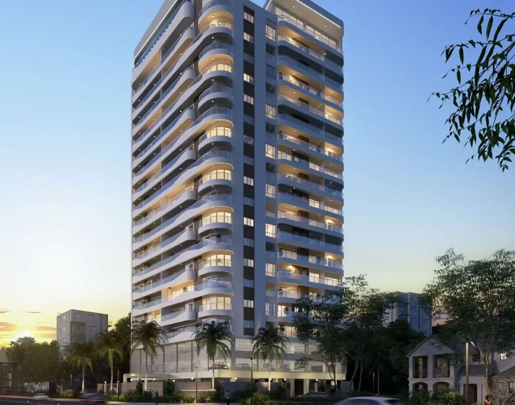 Modern high-rise tower of J & M Palms Residence Nairobi with curved balconies, illuminated façade and landscaped surroundings at sunset.