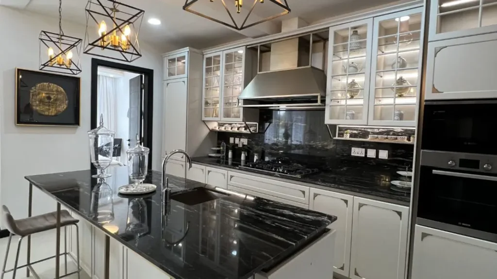 Modern fitted kitchen at J & M Palms Residence Nairobi with marble countertops, kitchen island, built-in oven and high-end cabinetry.