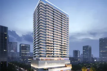 Oak Breeze Residency luxury high-rise apartment tower illuminated at dusk with branded podium entrance and Nairobi CBD skyline in the background