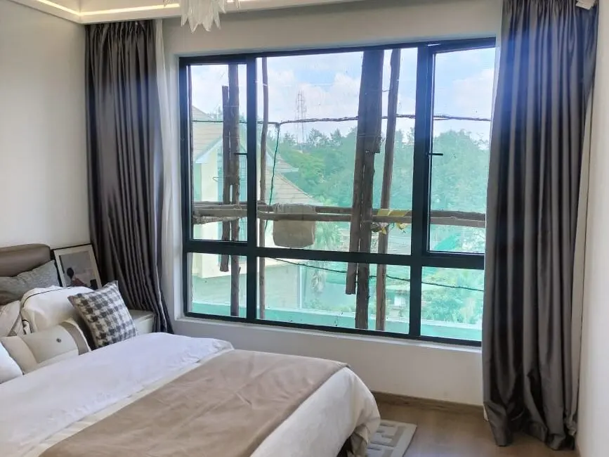 Spacious bedroom with large window at Riara One Residency Kilimani Nairobi